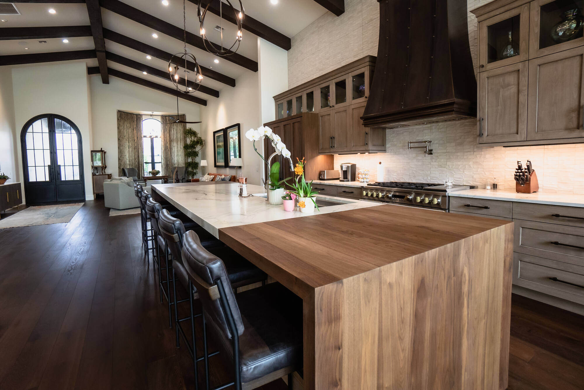 Open kitchen with wood and marble counters in a custom home by MGD Builders, Phoenix, AZ