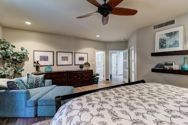 Custom home bedroom by MGD Builders in Phoenix, AZ with a cozy seating area and stylish décor