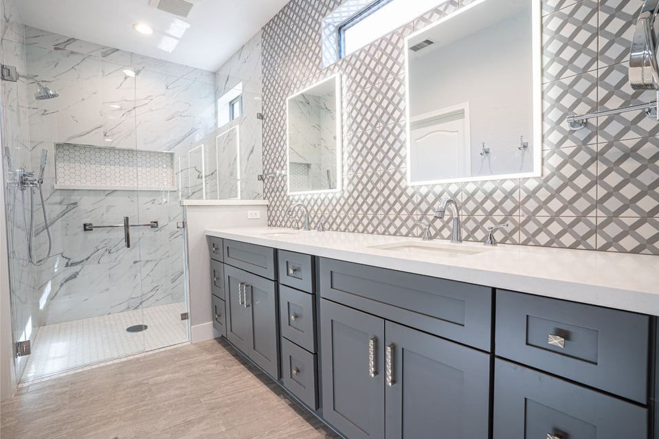 surprise arizona bathroom remodel with custom fixtures, gray cabinets, marble shower, and backlit mirrors