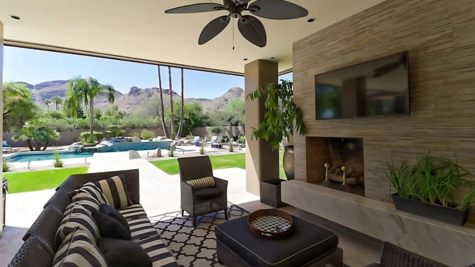 custom home in scottsdale with outdoor entertainment area and pool with mountain views