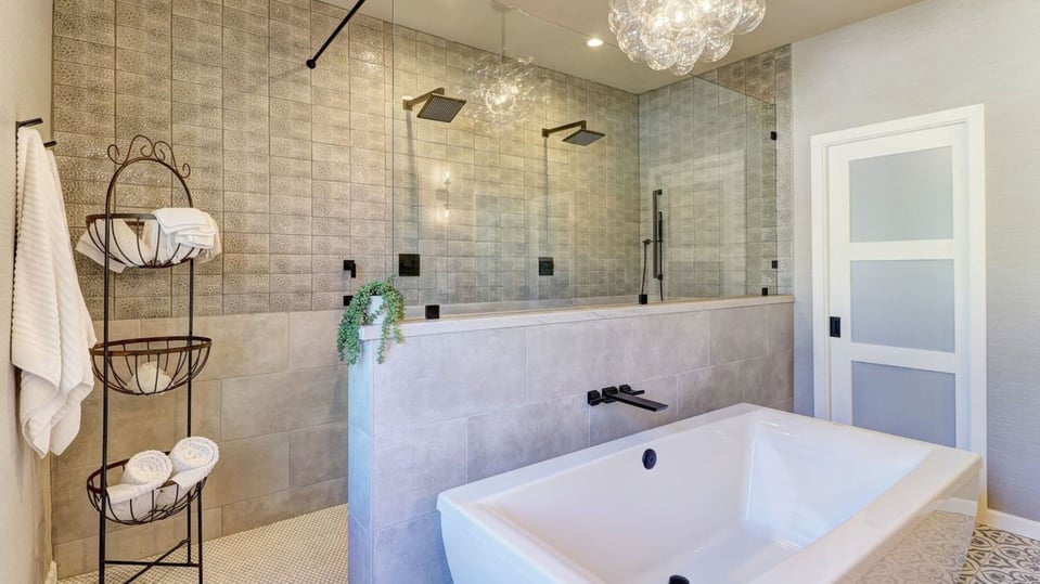 luxury bathroom remodel in phoenix az with free standing tub, double shower heads, and stone tiles