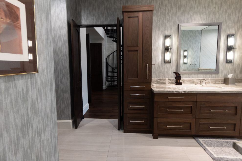 Large bathroom connected to bedroom with brown cabinets