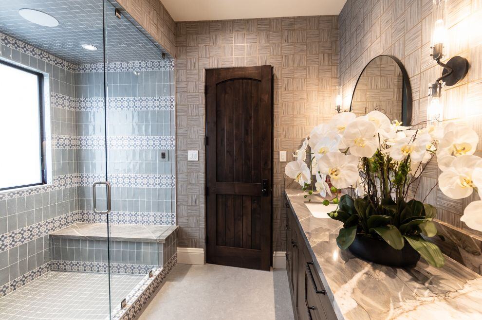 bathroom remodel in Phoeniz AZ with glass frameless shower with bench and custom finishes