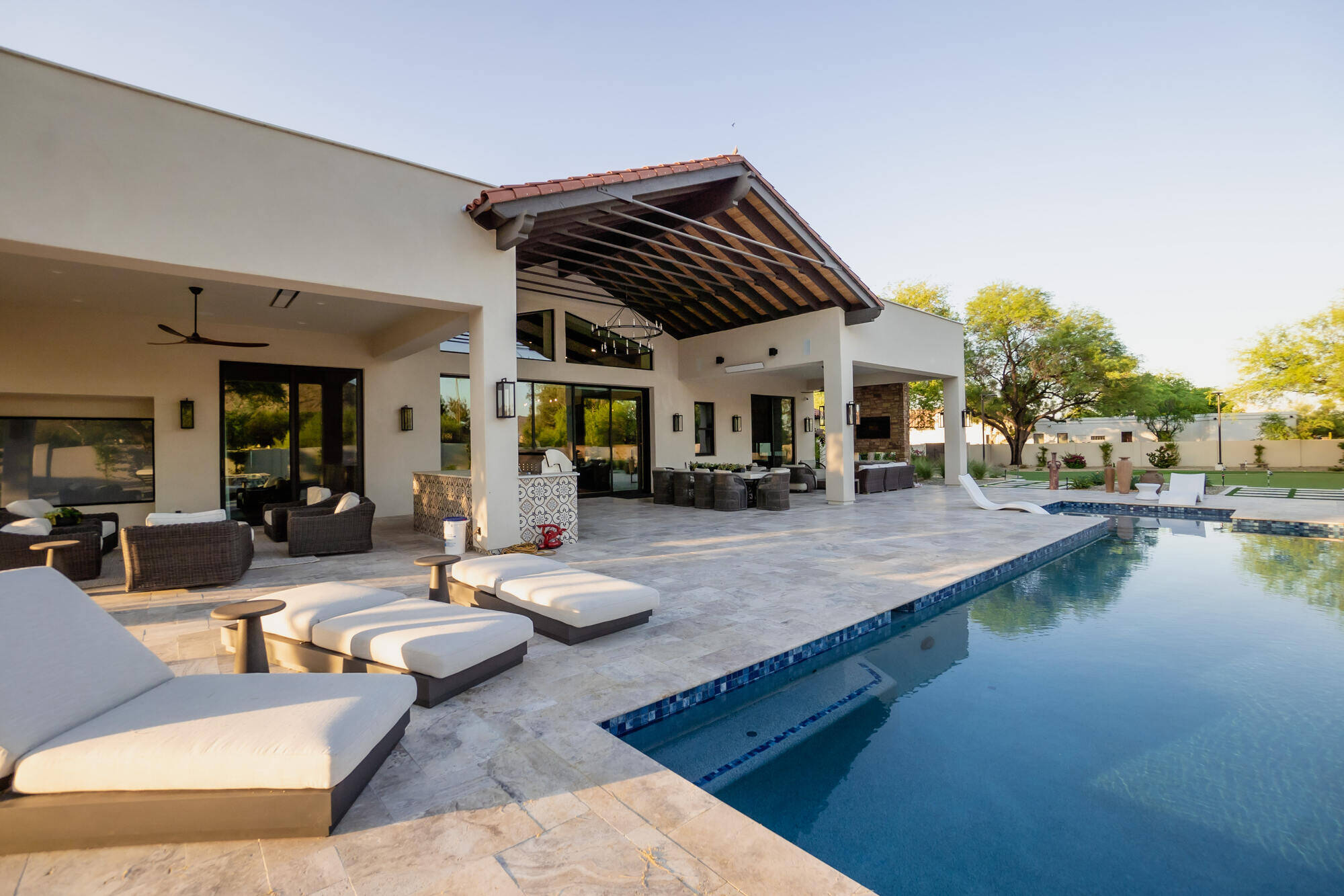 Custom home exterior with a luxurious pool and patio by MGD Builders in Phoenix, AZ