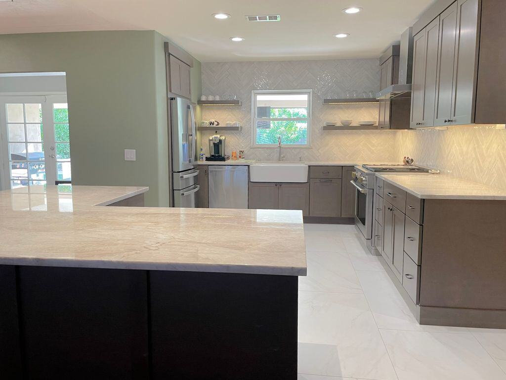 Open kitchen layout remodeled by MGD Builders in Phoenix, AZ, with modern appliances and elegant countertops