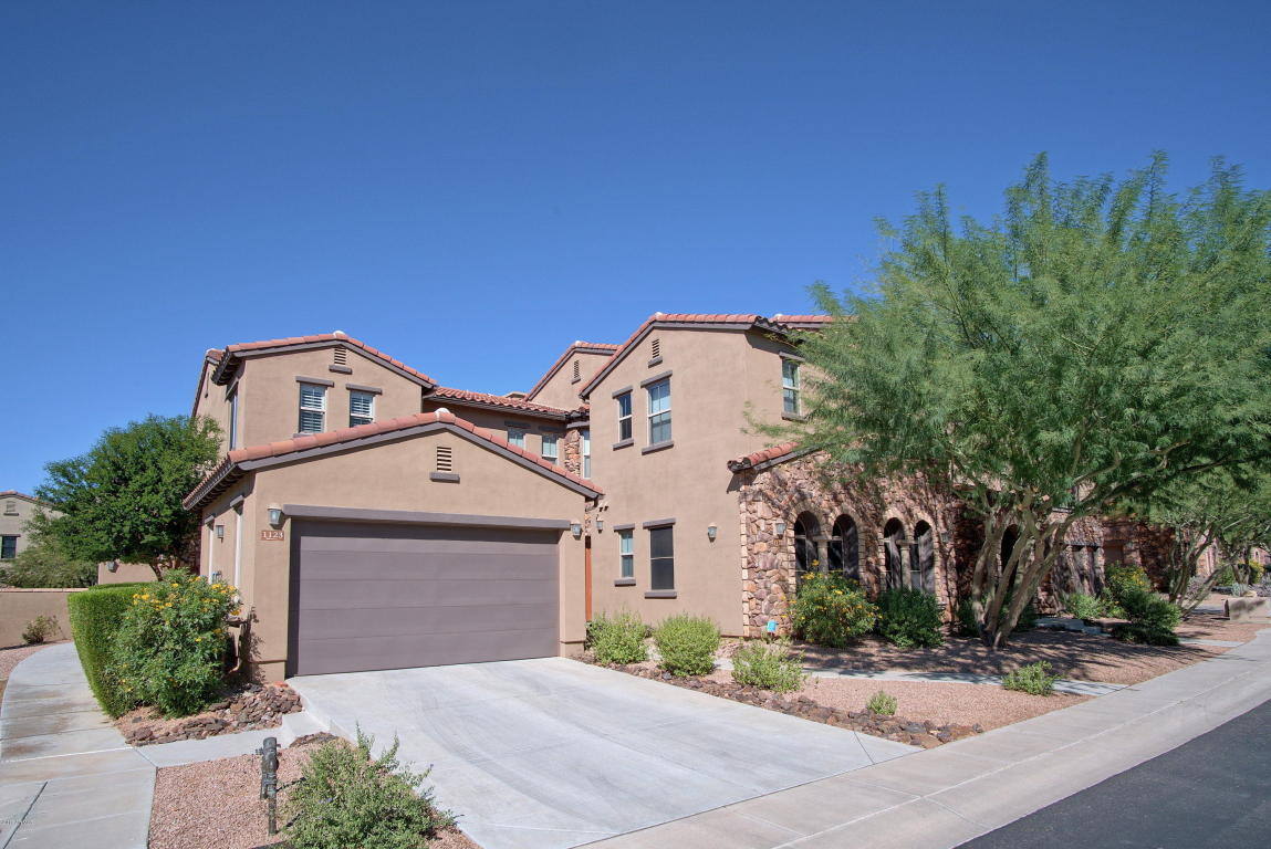 Exterior of a two-story stucco home with a garage and stone accents, remodeled by MGD Builders in Phoenix, AZ