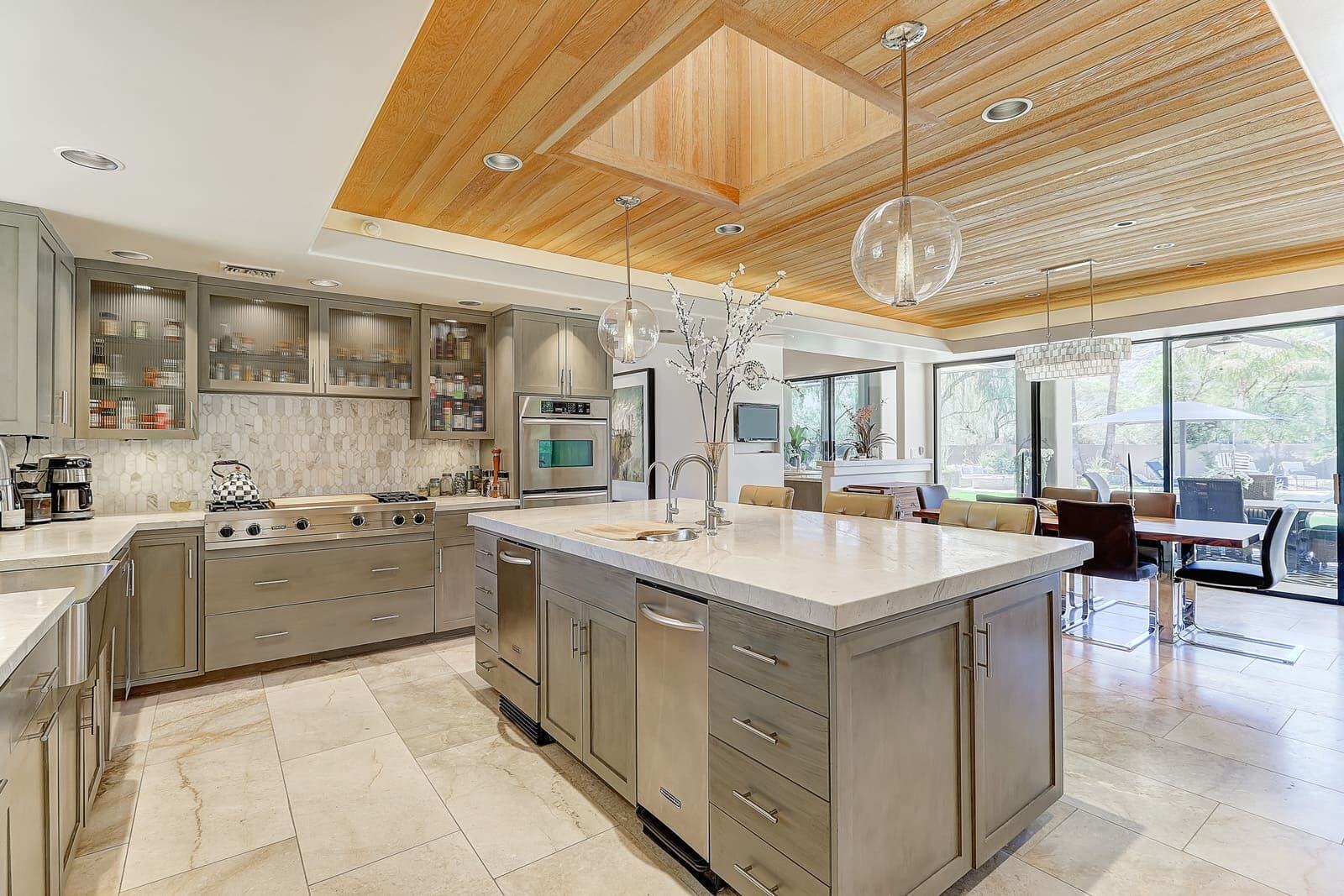 Custom-designed kitchen with marble counters and modern fixtures, part of MGD Builders home remodeling in Paradise Valley, Phoenix, AZ 